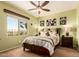 Cozy bedroom with a ceiling fan, green walls, and natural light at 19932 N Ibis Way, Maricopa, AZ 85138