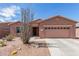 Charming home exterior with a well-manicured yard and desert landscaping at 19932 N Ibis Way, Maricopa, AZ 85138