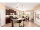 Well-equipped kitchen featuring dark cabinetry, stainless steel appliances, and a breakfast bar at 19932 N Ibis Way, Maricopa, AZ 85138