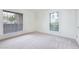 Bright bedroom with carpeted floors, windows with blinds, and a closet for storage at 200 E Southern Ave # 117, Tempe, AZ 85282