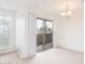 Comfortable living room with neutral carpet and sliding glass door to balcony and a light fixture at 200 E Southern Ave # 117, Tempe, AZ 85282