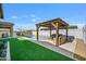 Lush backyard with a swimming pool, gazebo, artificial turf, and desert landscaping at 22744 E Stonecrest Dr, Queen Creek, AZ 85142