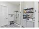Bathroom featuring a sleek glass shower, built-in storage, and patterned tile flooring for a modern aesthetic at 22744 E Stonecrest Dr, Queen Creek, AZ 85142