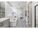 Spacious bathroom features a soaking tub, walk-in shower, and stylish black and white patterned tile flooring at 22744 E Stonecrest Dr, Queen Creek, AZ 85142