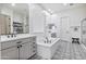 A luxurious primary bathroom featuring a large tub, dual vanity, and stylish black and white patterned floors at 22744 E Stonecrest Dr, Queen Creek, AZ 85142