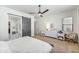 This is a bedroom showcasing a barn door entrance to the bathroom and a patterned comforter at 22744 E Stonecrest Dr, Queen Creek, AZ 85142