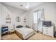 Bright bedroom featuring a geometric accent wall, sleek white furnishings and complementary neutral decor at 22744 E Stonecrest Dr, Queen Creek, AZ 85142