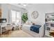Well-lit bedroom with a cozy daybed, desk, and a decorative mirror, offering a relaxing personal space at 22744 E Stonecrest Dr, Queen Creek, AZ 85142