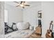 Cozy room with decorative wall, a guitar, bike and a ceiling fan at 22744 E Stonecrest Dr, Queen Creek, AZ 85142