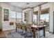 Open dining room with large windows, sliding doors, and built-in cabinetry perfect for entertaining guests at 22744 E Stonecrest Dr, Queen Creek, AZ 85142