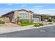 Attractive stucco home with manicured landscaping, showcasing its curb appeal and charming desert setting at 22744 E Stonecrest Dr, Queen Creek, AZ 85142