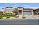 Charming single-story home with a well-manicured front yard and a neutral color palette, showcasing its curb appeal at 22744 E Stonecrest Dr, Queen Creek, AZ 85142
