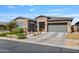 Beautiful stucco home featuring a multi-car garage, desert landscaping, and inviting curb appeal on a sunny day at 22744 E Stonecrest Dr, Queen Creek, AZ 85142