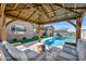 Covered gazebo with outdoor seating and a view of the swimming pool at 22744 E Stonecrest Dr, Queen Creek, AZ 85142