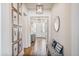 Bright hallway featuring wood-look tile flooring and a decorative bench seating, perfect for welcoming guests at 22744 E Stonecrest Dr, Queen Creek, AZ 85142
