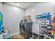 Convenient laundry room featuring modern washer and dryer units and ample storage shelving at 22744 E Stonecrest Dr, Queen Creek, AZ 85142