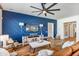 Inviting living room featuring an accent wall, ceiling fan, and comfortable seating arrangement at 22744 E Stonecrest Dr, Queen Creek, AZ 85142