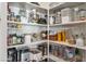Well-organized walk-in pantry featuring adjustable shelving and ample storage space for kitchen essentials at 22744 E Stonecrest Dr, Queen Creek, AZ 85142