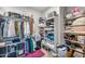 A well-organized walk-in closet features ample shelving, hanging racks, and storage for clothing and accessories at 22744 E Stonecrest Dr, Queen Creek, AZ 85142
