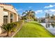 Beautiful backyard features manicured lawn and a serene waterfront view with lush landscape at 2395 W Riverside St, Chandler, AZ 85248