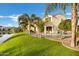 Expansive backyard featuring a pool, lush lawn, palm trees and waterfront views at 2395 W Riverside St, Chandler, AZ 85248