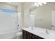 Bathroom showcasing a double sink vanity, a large mirror and a shower and tub combination at 2395 W Riverside St, Chandler, AZ 85248