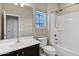 Bathroom with a single sink vanity, shower and tub, and a window for natural light at 2395 W Riverside St, Chandler, AZ 85248
