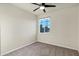 Bright bedroom featuring neutral carpet, a ceiling fan, and a window with a view at 2395 W Riverside St, Chandler, AZ 85248