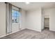 Cozy bedroom with carpet, a large window, neutral walls, and an ensuite closet at 2395 W Riverside St, Chandler, AZ 85248