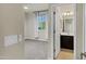 Bedroom with an ensuite bathroom, carpet flooring, and a bright window at 2395 W Riverside St, Chandler, AZ 85248
