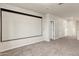 Large bonus room with a projector screen, perfect for a home theater setup, with carpet flooring at 2395 W Riverside St, Chandler, AZ 85248