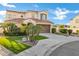 Well-manicured home exterior with lawn, decorative trees and large driveway leading to a two-car garage at 2395 W Riverside St, Chandler, AZ 85248