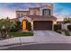 Inviting front exterior with a tile roof, two car garage and mature landscaping at 2395 W Riverside St, Chandler, AZ 85248