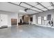Spacious garage with epoxy flooring, overhead racks, and a Tesla Powerwall at 2395 W Riverside St, Chandler, AZ 85248