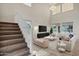 Spacious living room with high ceilings, a staircase, neutral decor, and lots of natural light at 2395 W Riverside St, Chandler, AZ 85248