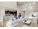 Open-concept living room with a staircase, white couches, and modern decor at 2395 W Riverside St, Chandler, AZ 85248