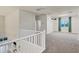 Bright and spacious loft area with neutral carpeting, perfect for relaxation or a playroom at 2395 W Riverside St, Chandler, AZ 85248