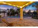 Covered patio offers views of the pool, scenic waterfront, with desert landscaping and is ideal for outdoor relaxation at 2395 W Riverside St, Chandler, AZ 85248
