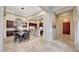 Spacious dining area with a stylish table set for a meal, flowing into the kitchen and living spaces at 29512 N 128Th Ln, Peoria, AZ 85383