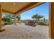 Covered patio featuring a fountain, fire pit, and views at 29512 N 128Th Ln, Peoria, AZ 85383