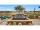 A tiered water feature with desert views, set amidst lush landscaping in the backyard at 29512 N 128Th Ln, Peoria, AZ 85383