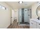 Updated bathroom features a new glass shower enclosure and modern sink and fixtures at 3021 N Randolph Rd, Phoenix, AZ 85014