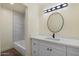 Bathroom showcasing a single vanity with quartz countertop and the shower-tub combo with gray and white tile at 3021 N Randolph Rd, Phoenix, AZ 85014