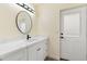 Bathroom featuring white single vanity with quartz countertop, black hardware, and walkout door at 3021 N Randolph Rd, Phoenix, AZ 85014