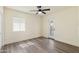 Bedroom with wood-look flooring, a ceiling fan, a window with blinds, and a door at 3021 N Randolph Rd, Phoenix, AZ 85014