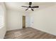 Spacious bedroom with ceiling fan, wood-look flooring, closet, and white walls at 3021 N Randolph Rd, Phoenix, AZ 85014
