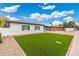 Well maintained front lawn on a single story home with gray shutters and covered parking at 3021 N Randolph Rd, Phoenix, AZ 85014