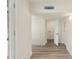 A well-lit hallway with access to the laundry room and backyard at 3021 N Randolph Rd, Phoenix, AZ 85014