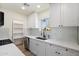 Modern kitchen features white cabinets, quartz countertops, stainless appliances and wood look floors at 3021 N Randolph Rd, Phoenix, AZ 85014