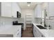 Bright white kitchen features modern appliances, white cabinets, quartz counters, and a pantry at 3021 N Randolph Rd, Phoenix, AZ 85014